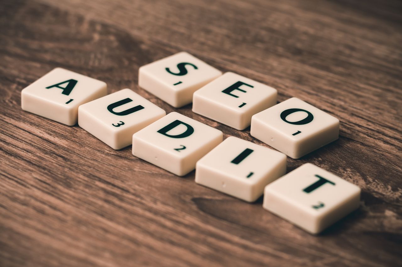 Mastering the First Impression: Your intriguing post title goes here Scrabble tiles spelling SEO Audit on wooden surface, symbolizing digital marketing strategies.