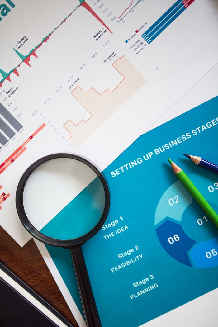 Services Magnifying glass and charts illustrate business analysis and planning concepts.